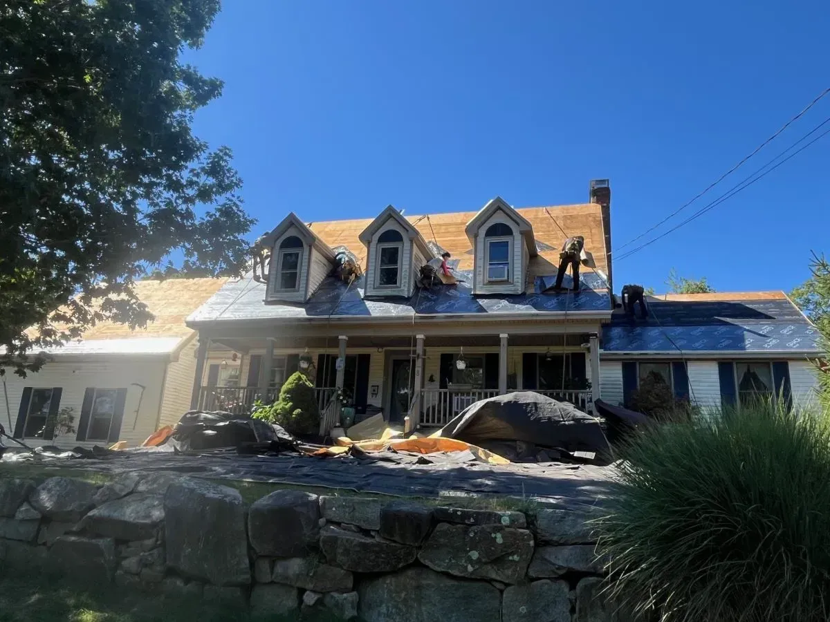 A large house with a roof that is being repaired.