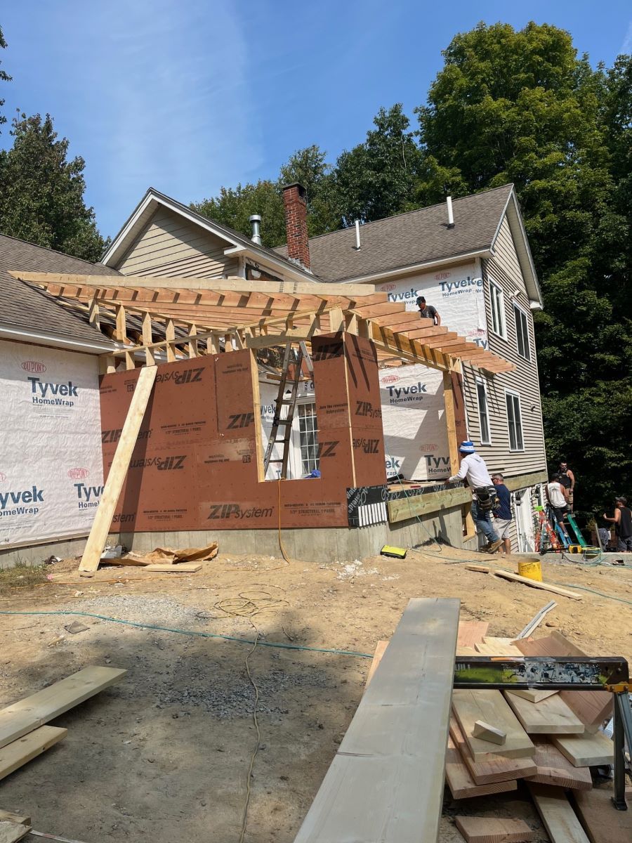A house is being remodeled with a wooden frame.