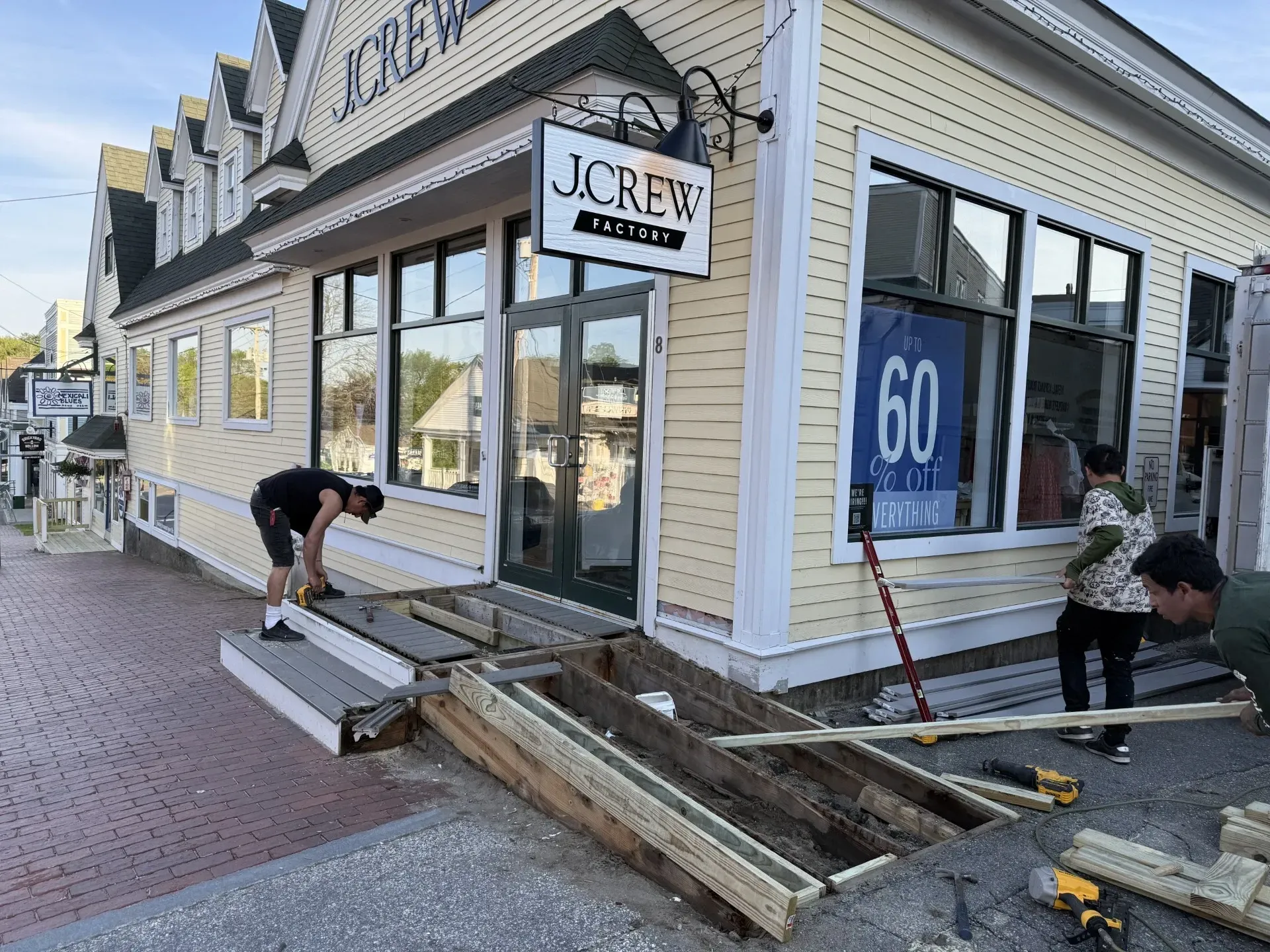 A group of people are working outside of a building.