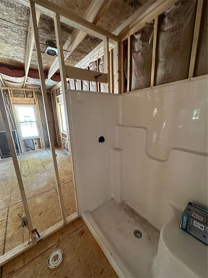 A bathroom under construction with a shower and toilet.