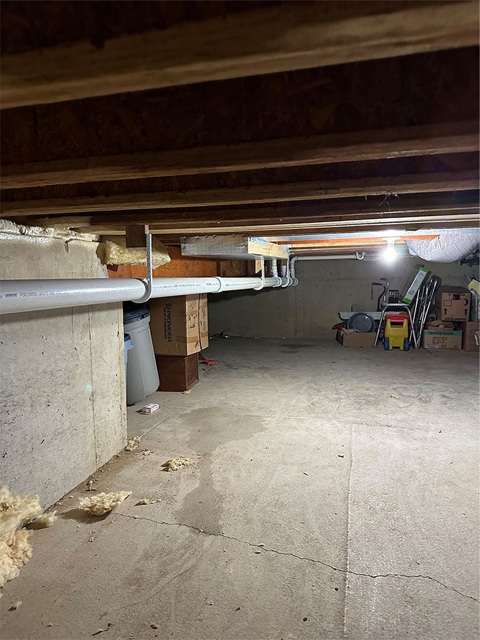 A basement with a lot of boxes and a light on the ceiling.