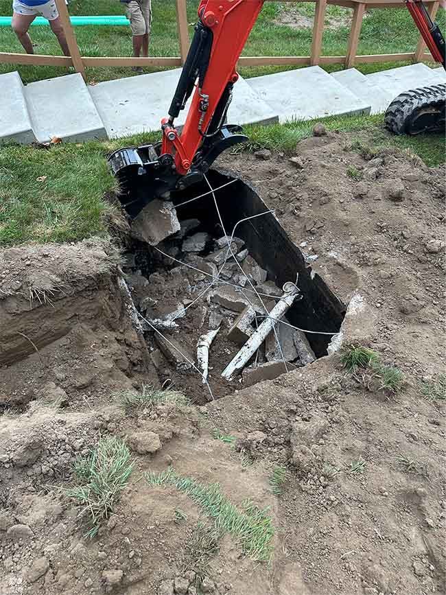 An excavator is digging a hole in the ground.