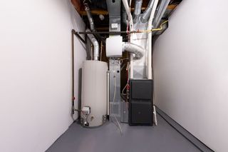 A basement with a water heater and a furnace.