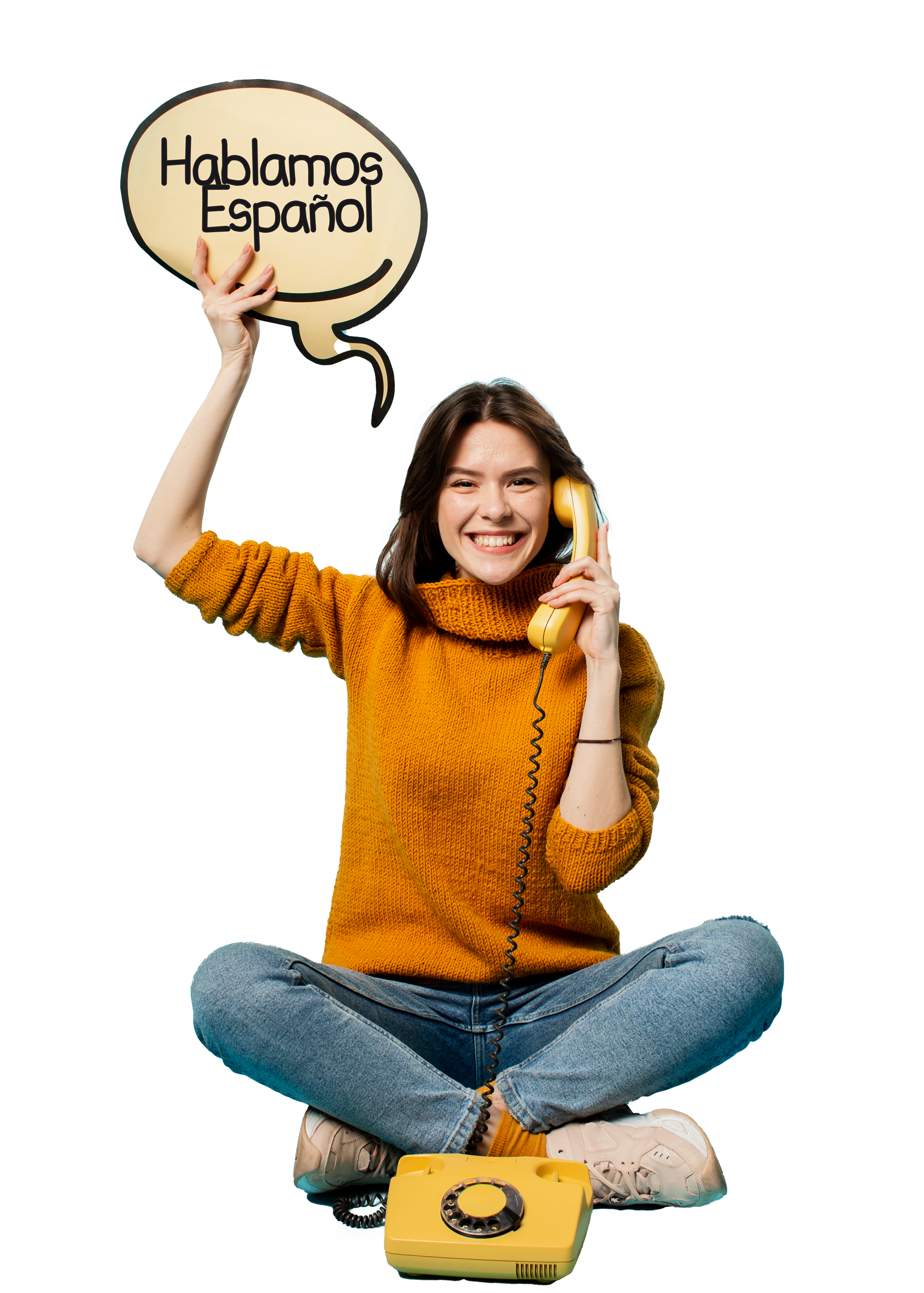 A woman is sitting on the floor talking on a yellow telephone.