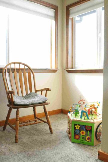 Wooden chair beside the window — Restorative Dentistry in Woodland Park,CO