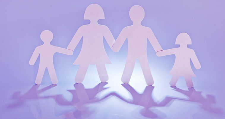Cut-out figures of parents and two children holding hands
