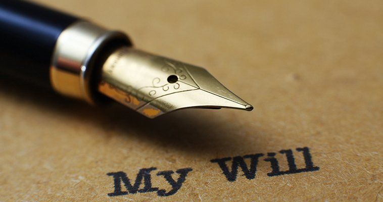 A fountain pen with a gold nib, on a document named 