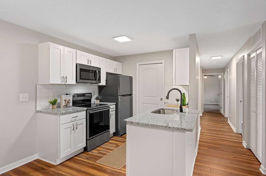 Interior Photo of 860 East Kitchen with White Cabinets and Black Appliances