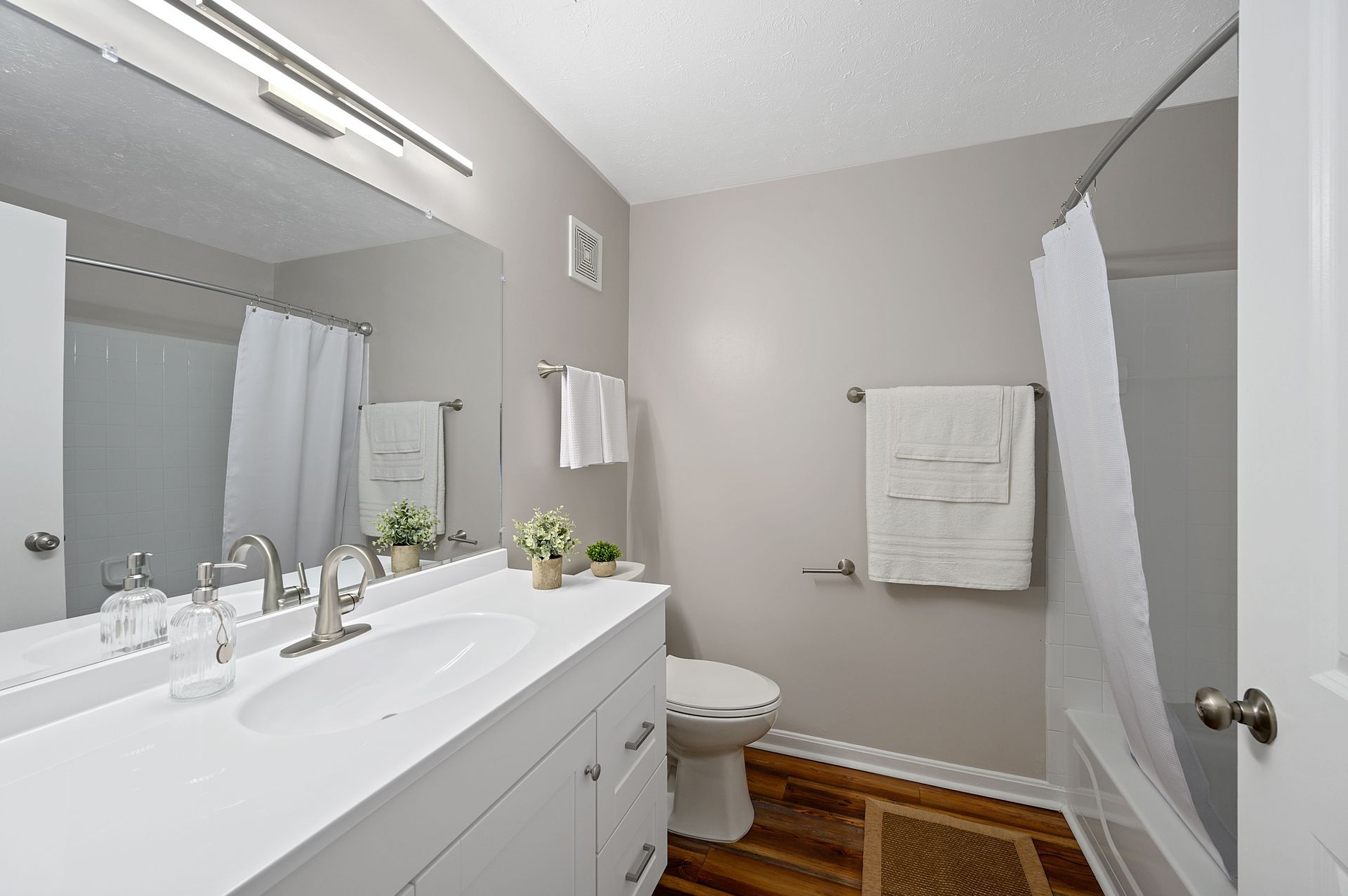 a bathroom with a toilet , sink , and mirror