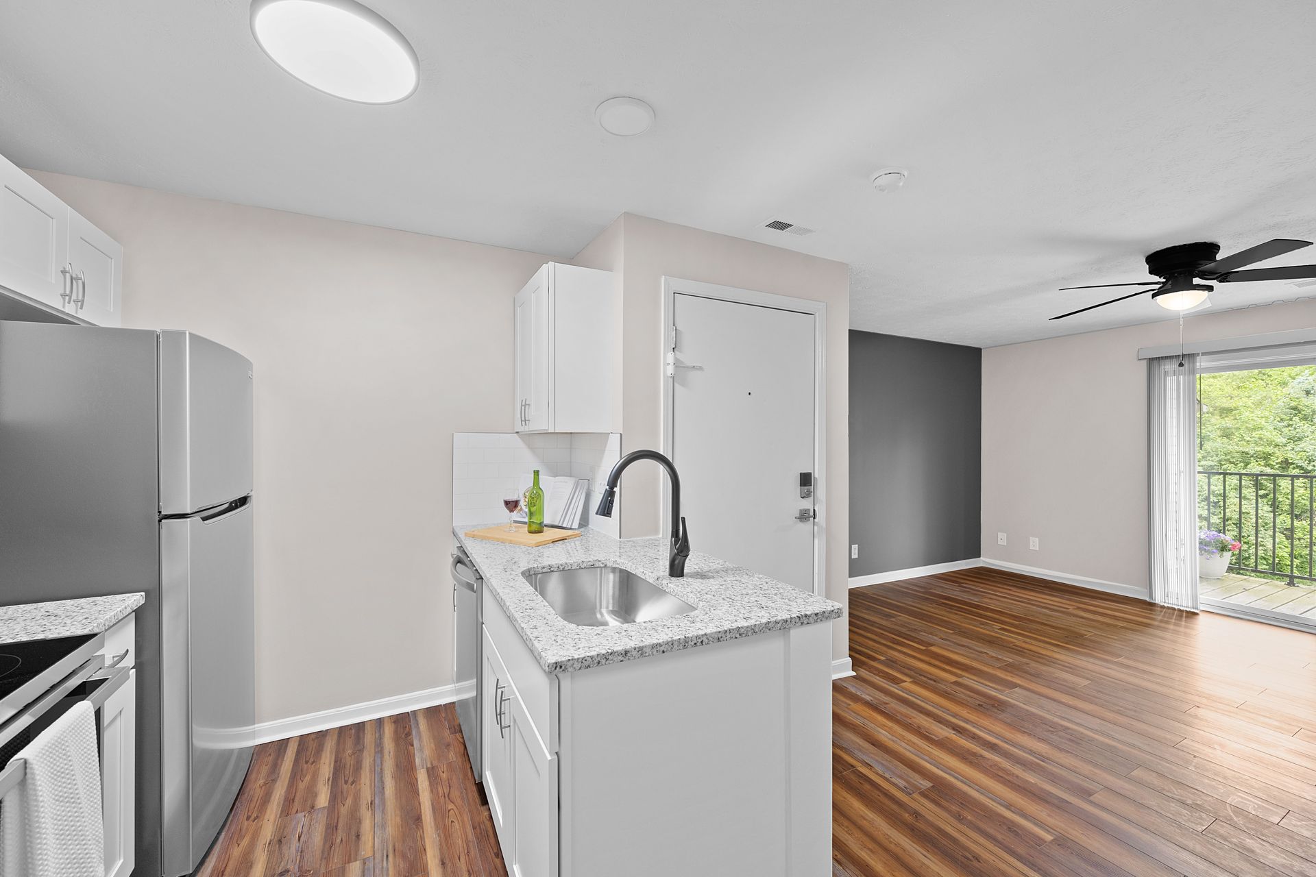 Bridgewater Crossing kitchen with stainless steel appliances and adjoining living space