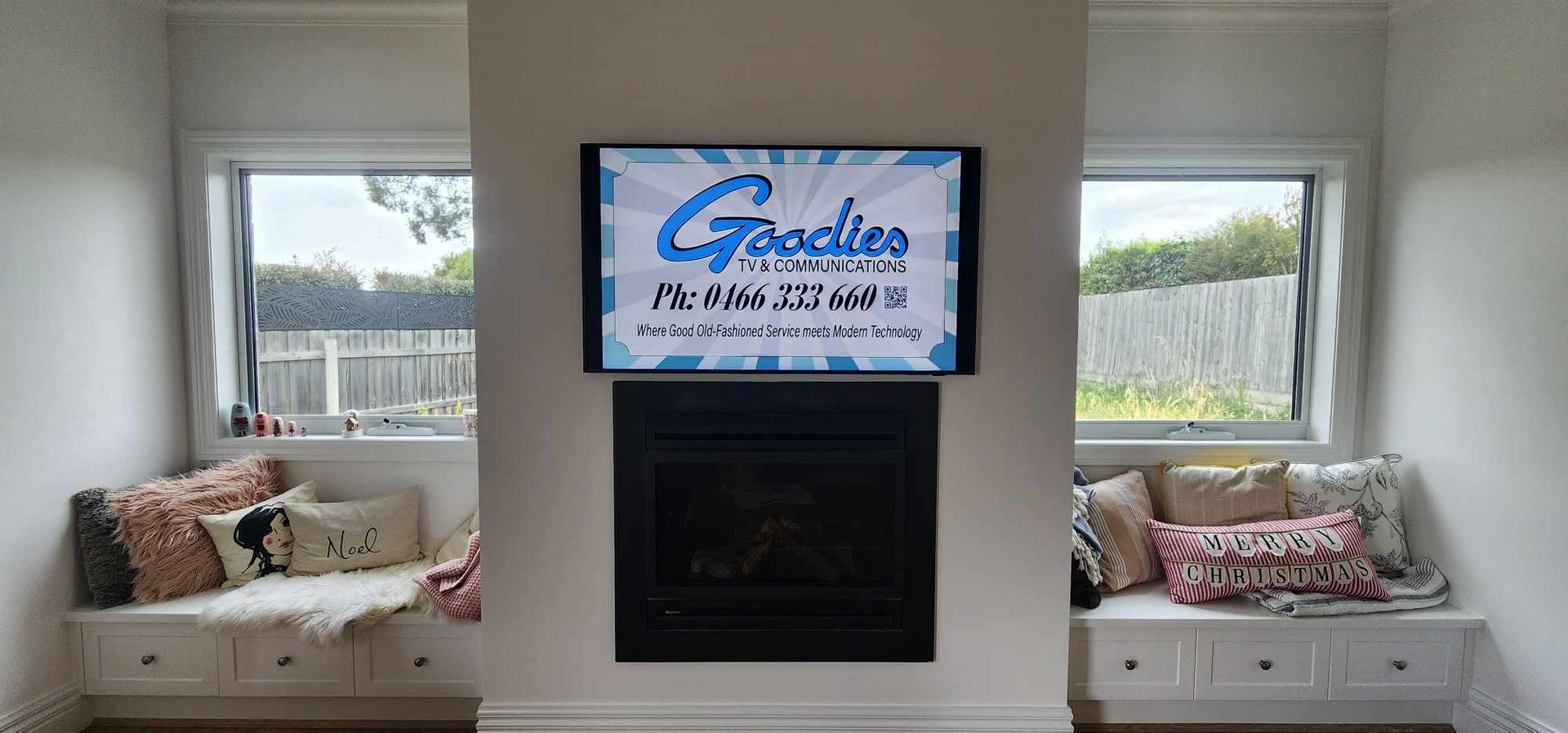 a living room with a fireplace and a television on the wall .