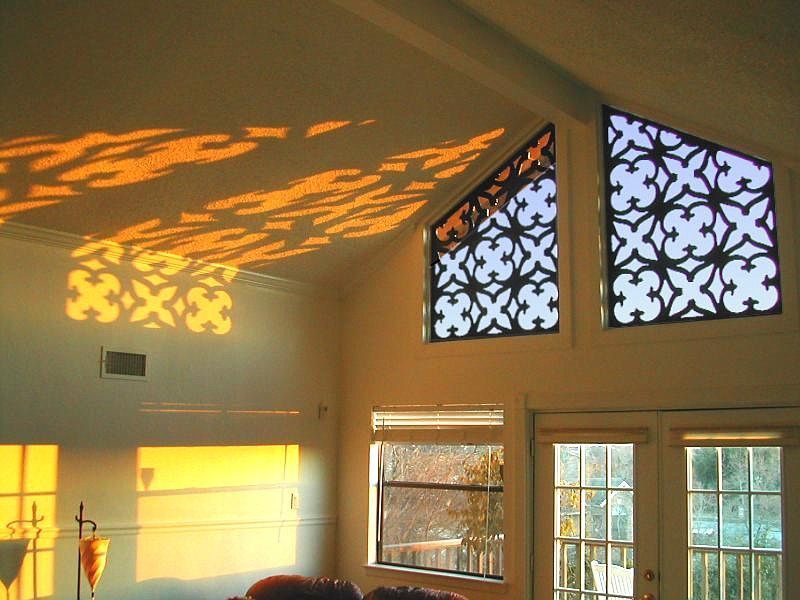 A living room with a vaulted ceiling and stained glass windows