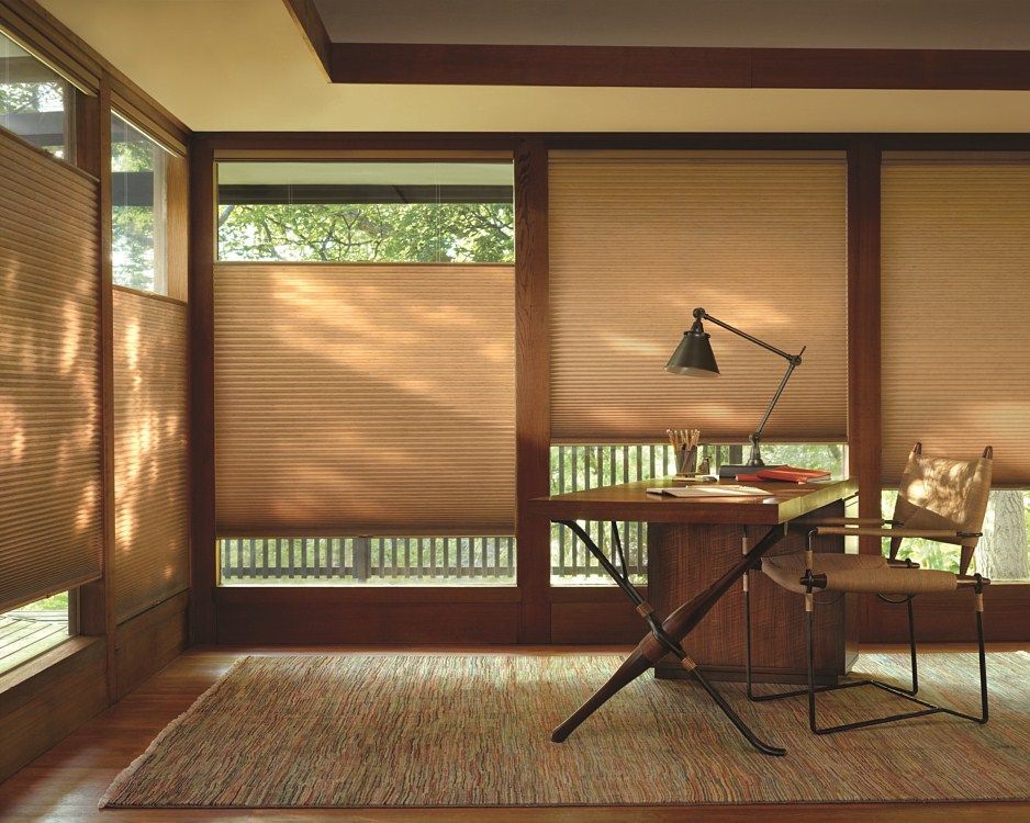 A room with a desk and chair and a lamp