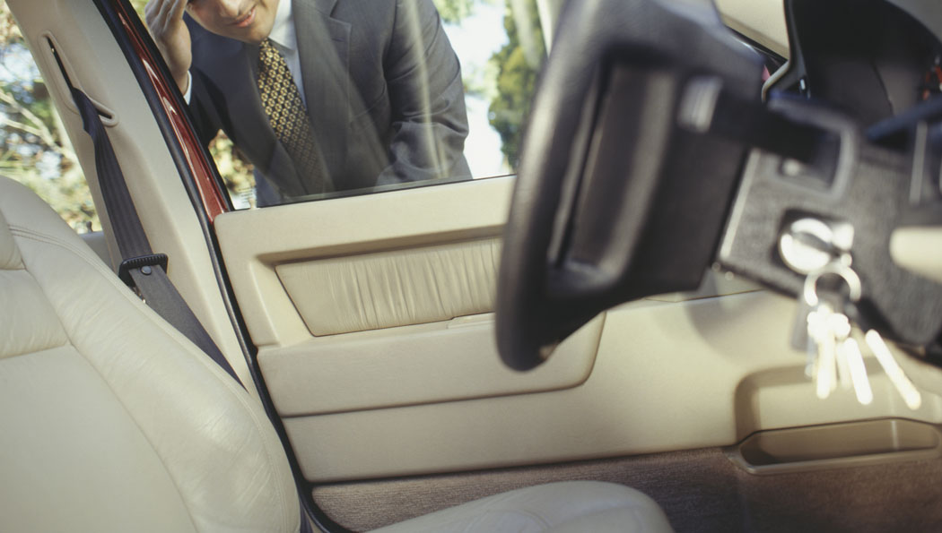 A person is pumping air into a car tire.