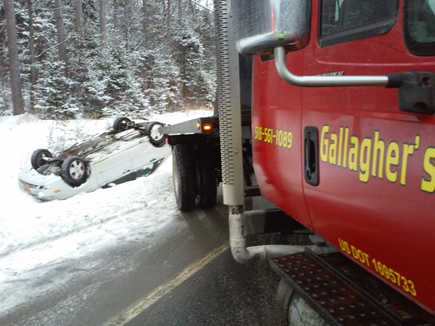 A red tow truck with gallagher 's written on the side