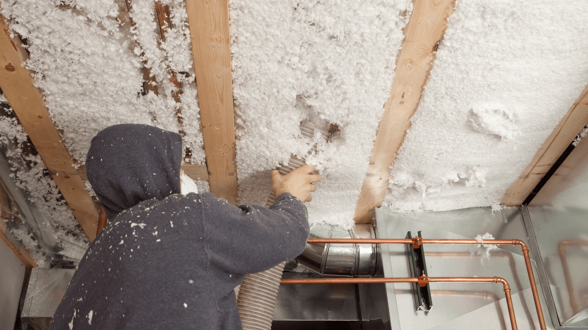 man using blown-in insulation