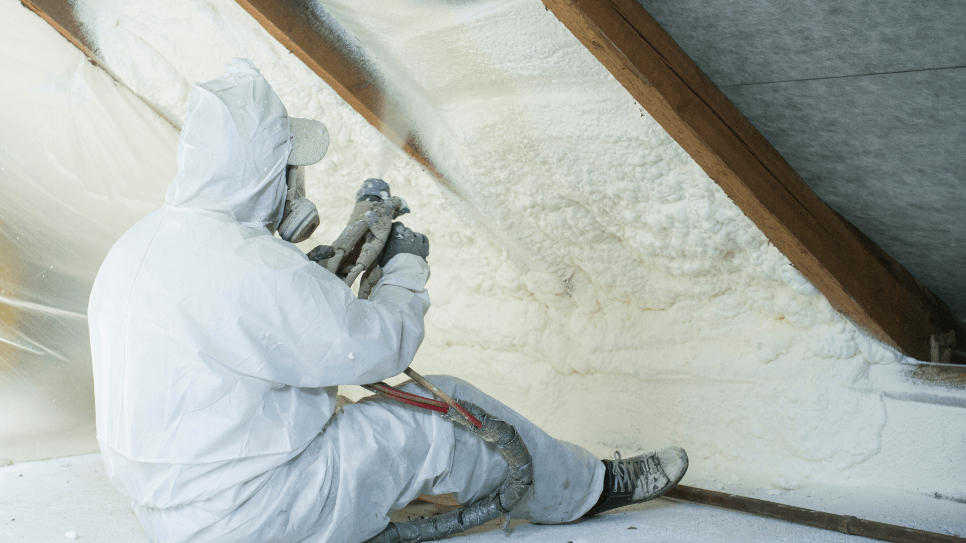 man spraying foam insulation