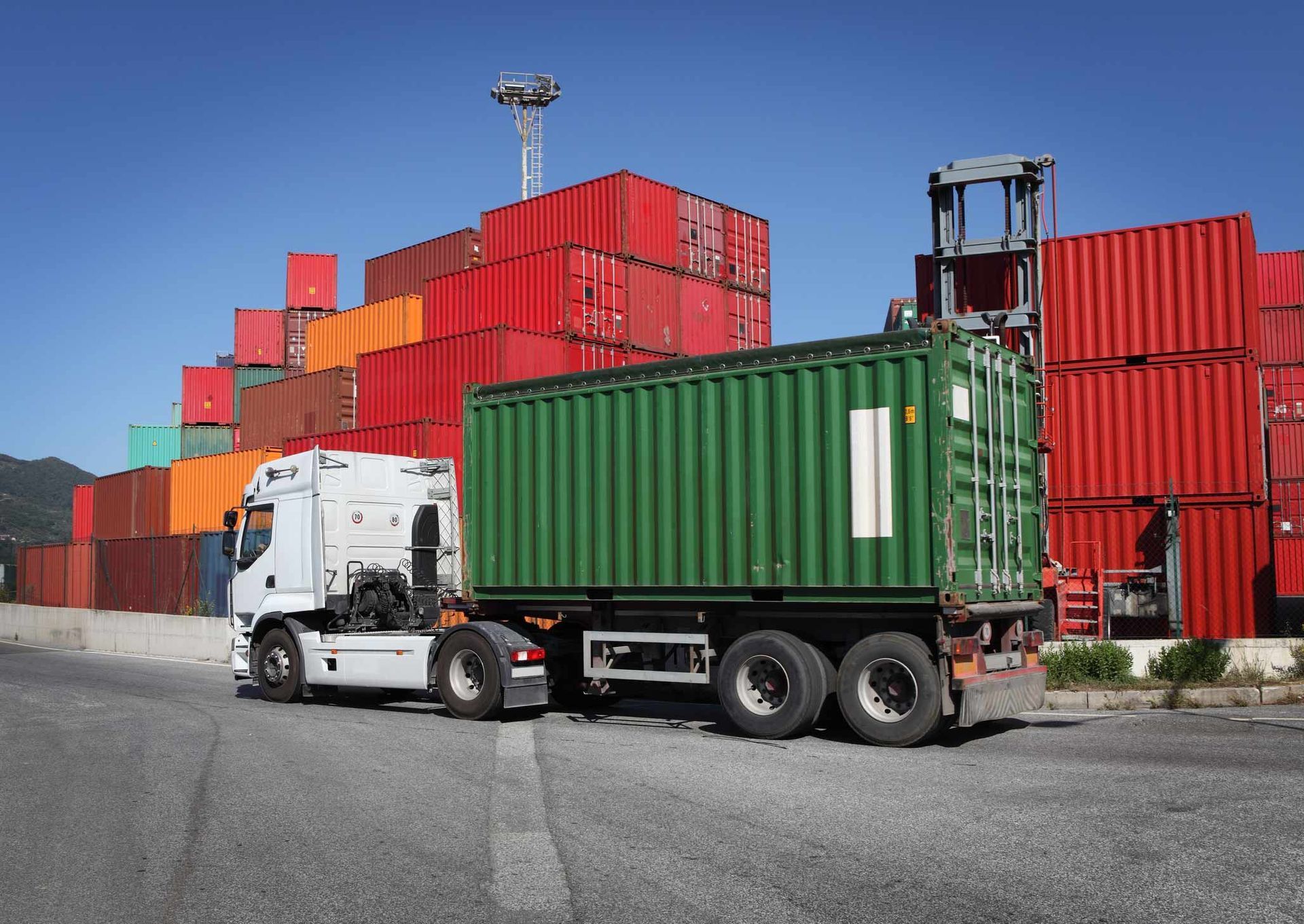 Truck delivering cargo container | Dry Creek, SA | Spectrum Transport Systems Pty Ltd