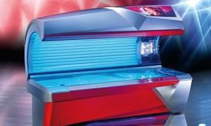 Tanning bed; red and silver exterior with blue UV light interior.