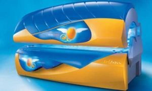 Yellow and blue tanning bed with blue lights.