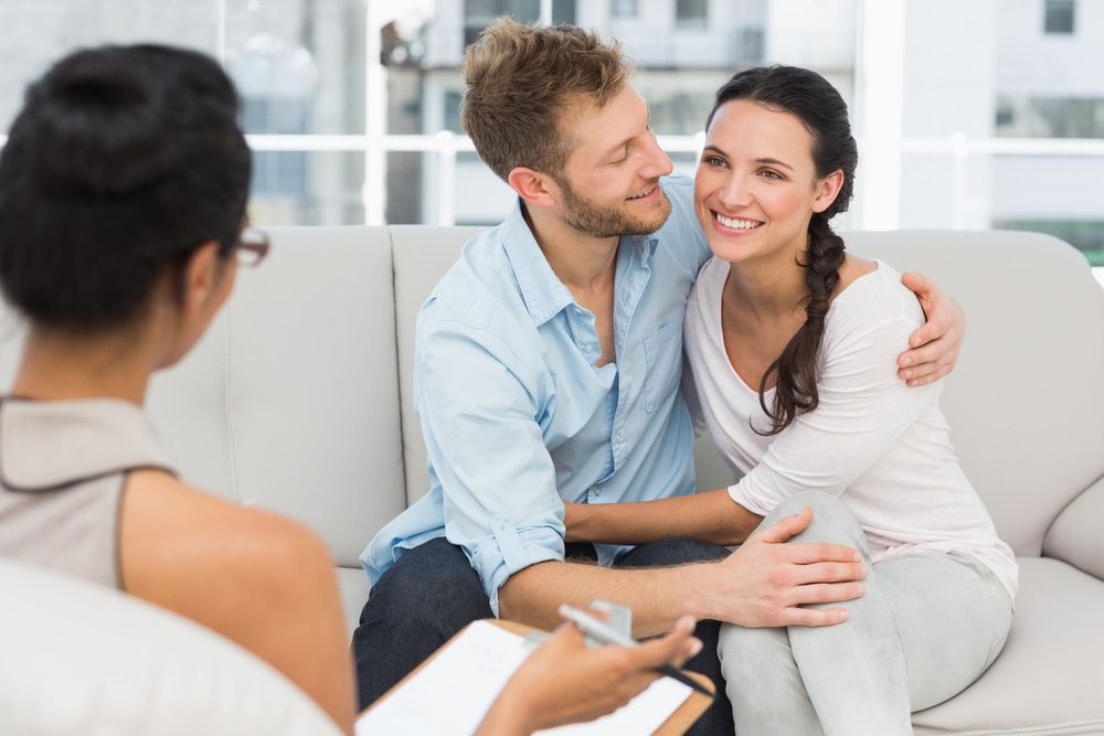 Man And A Woman Are Sitting On A Couch Having A Counselling — Unique By Nature Allied Health Service In Burpengary, QLD