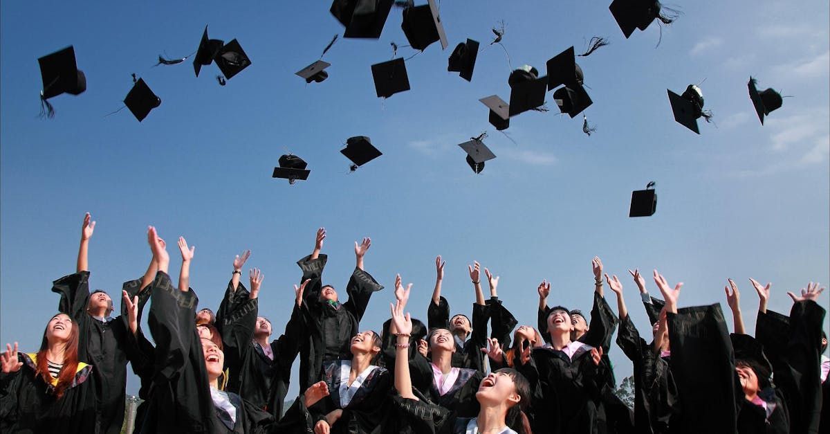 A group of graduates are throwing their caps in the air.