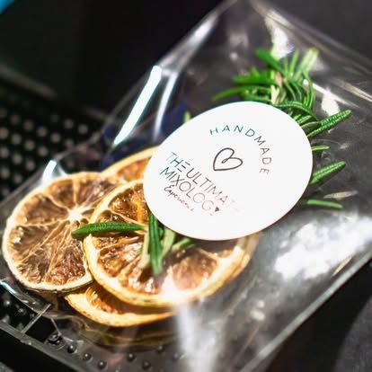 A bag of dried citrus slices with a handmade sticker on it