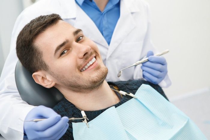 man sitting on a dental chair