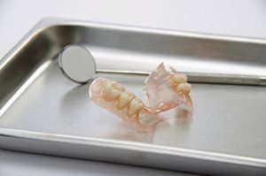 old denture lying on the tray