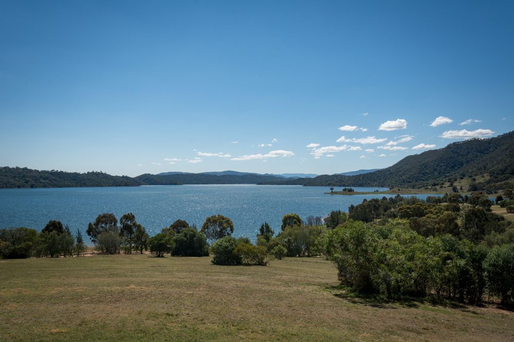 A Large Body Of Water Surrounded By Trees And Grass On A Sunny Day — CG Plumbing & Drainage In Scone, NSW