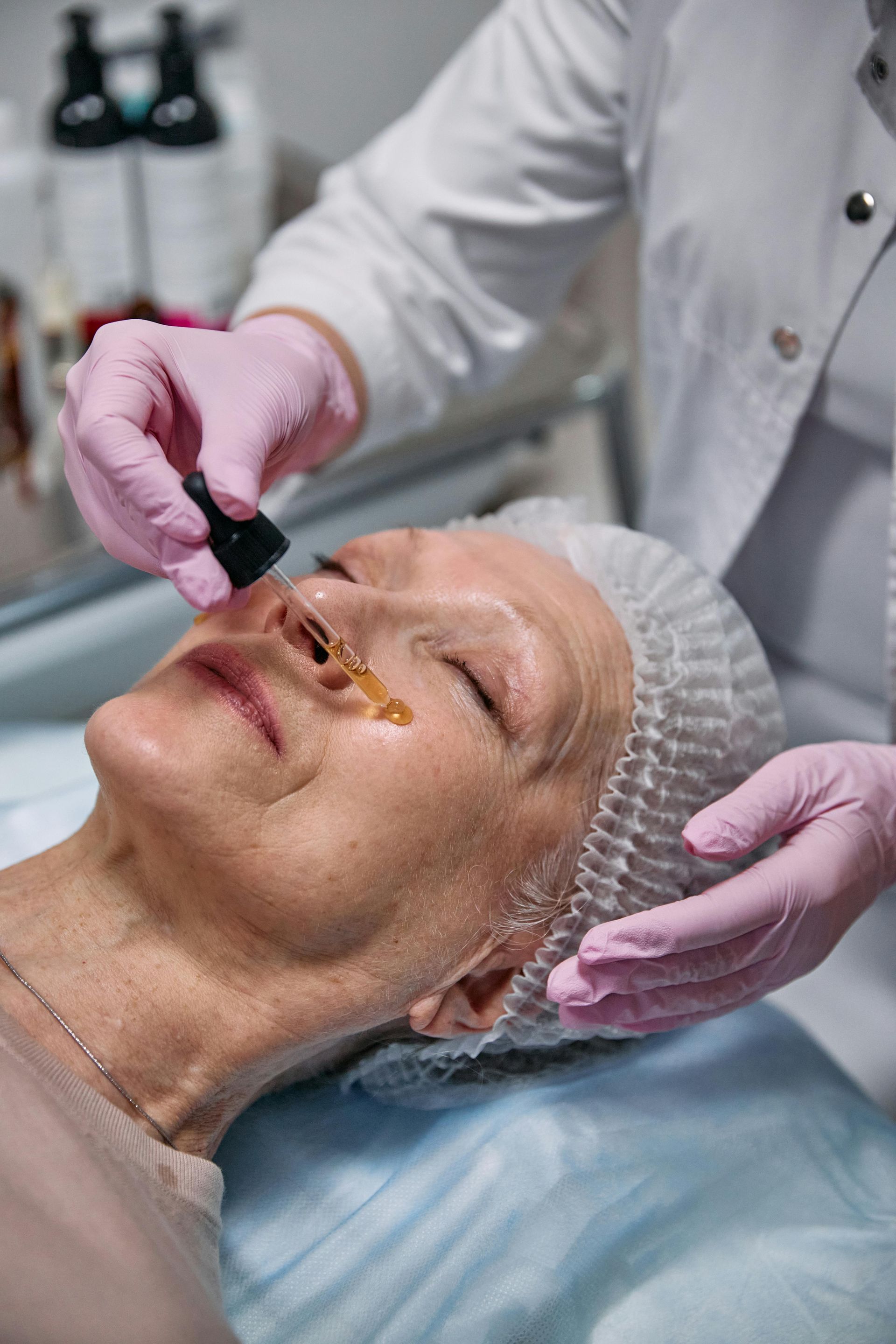 A woman is getting a peeling treatment at a beauty salon.