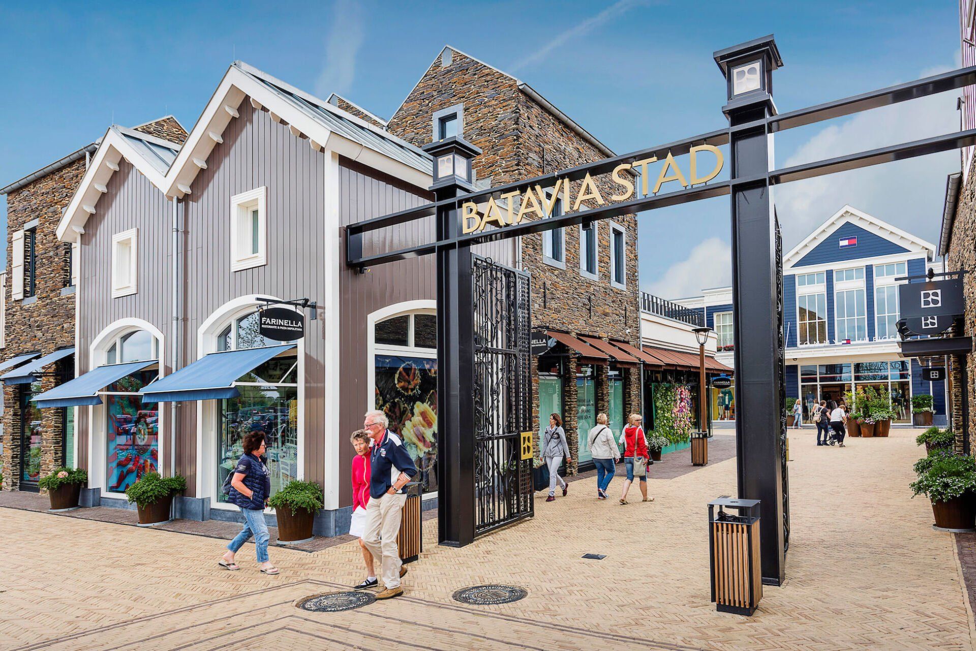 A group of people are walking around a shopping mall.
