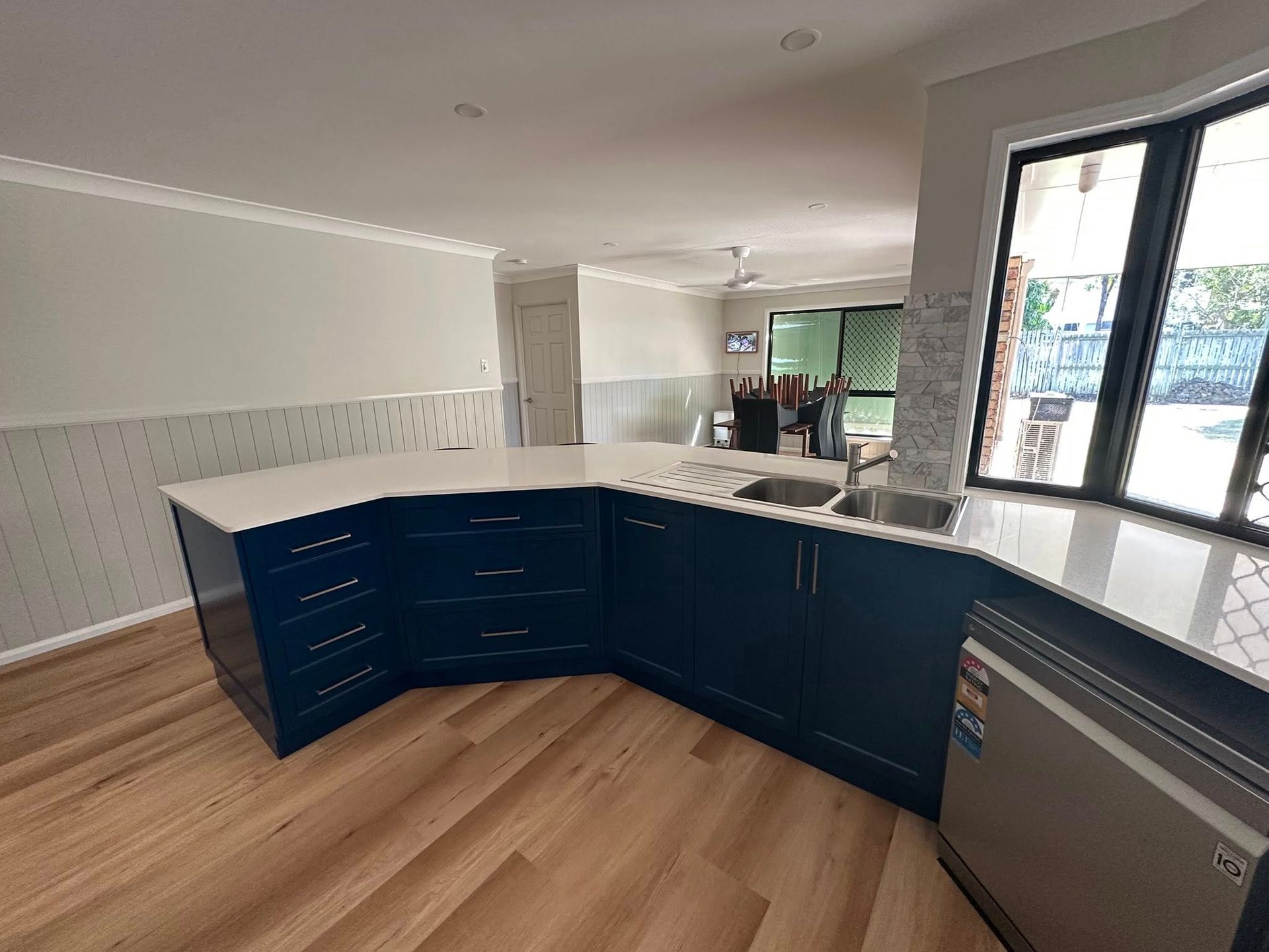 Modern Kitchen with Blue Cabinets, White Countertop, and Wood-Look Flooring — Valley Cabinetmakers In Biloela, QLD 
