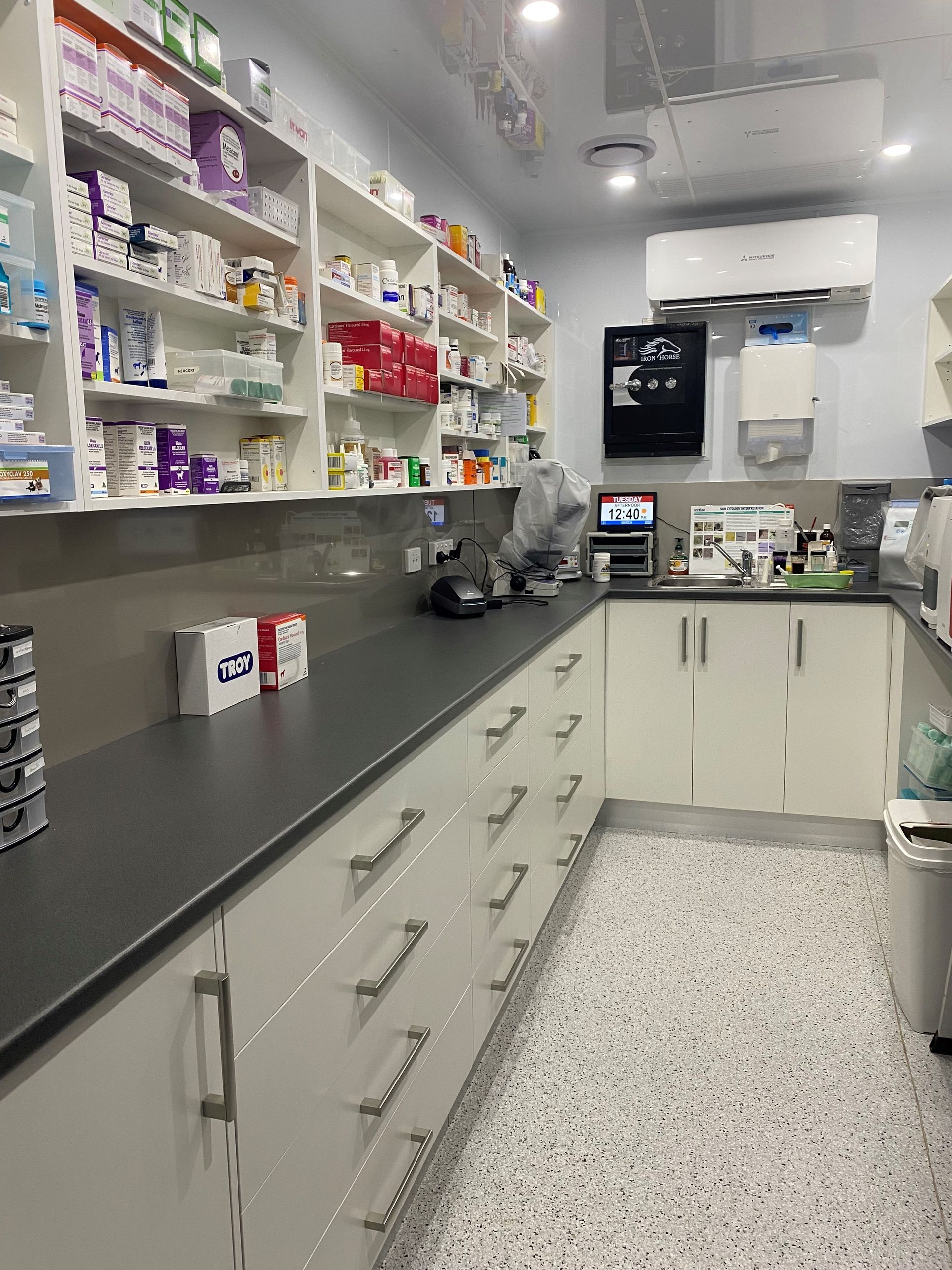 Kitchen with White Cabinets, Dark Wood Beams, and Hardwood Floors — Valley Cabinetmakers In Biloela, QLD 