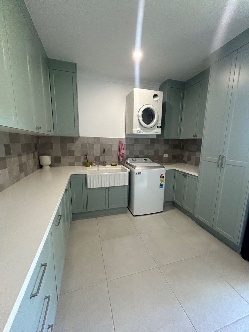 Laundry Room with Mint Cabinets, White Countertops, and White Appliances — Valley Cabinetmakers In Biloela, QLD 