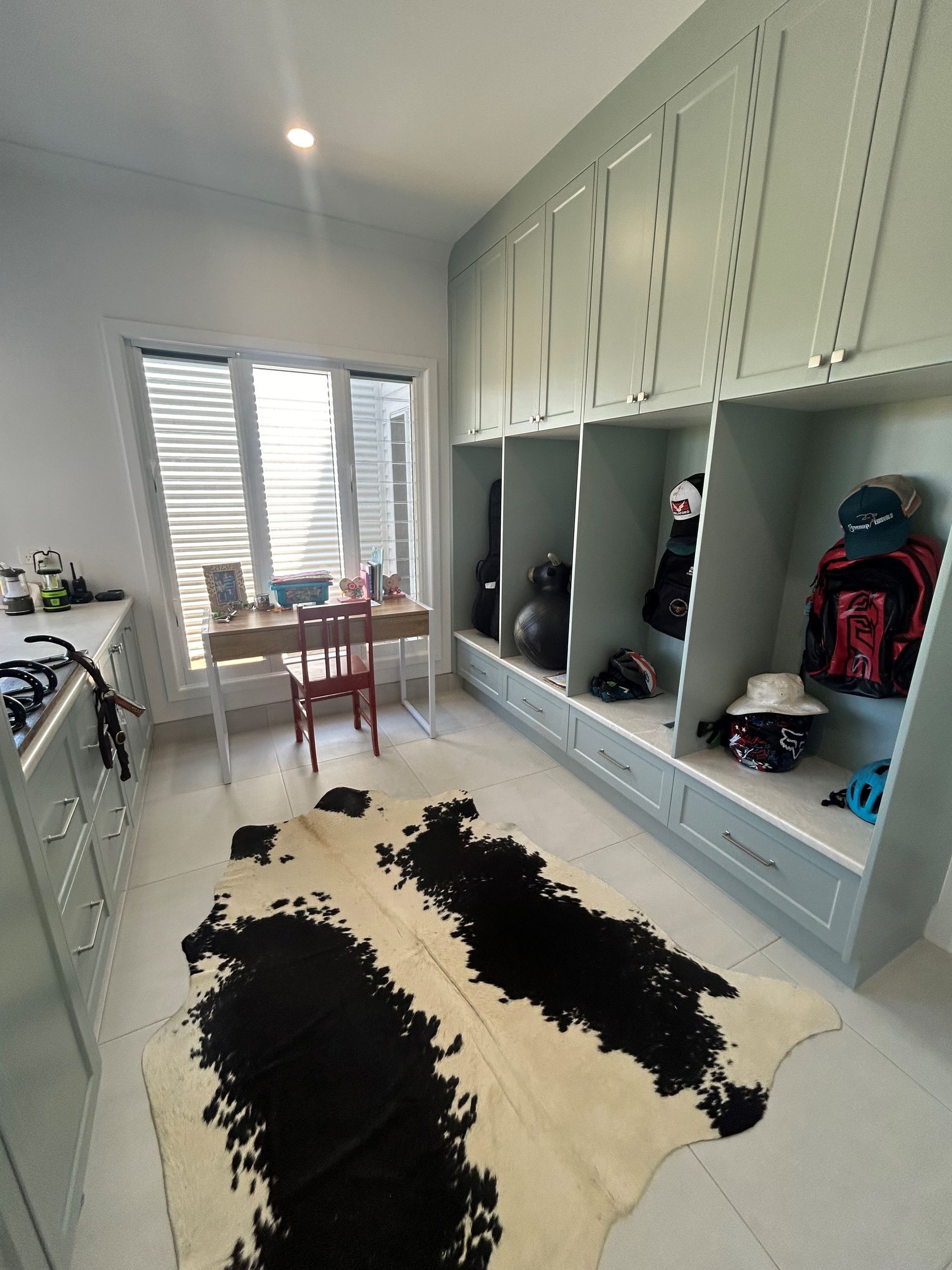 Bright hallway-style room with built-in cabinets, window light, small table, and black-and-white rug. — Valley Cabinetmakers In Biloela, QLD 