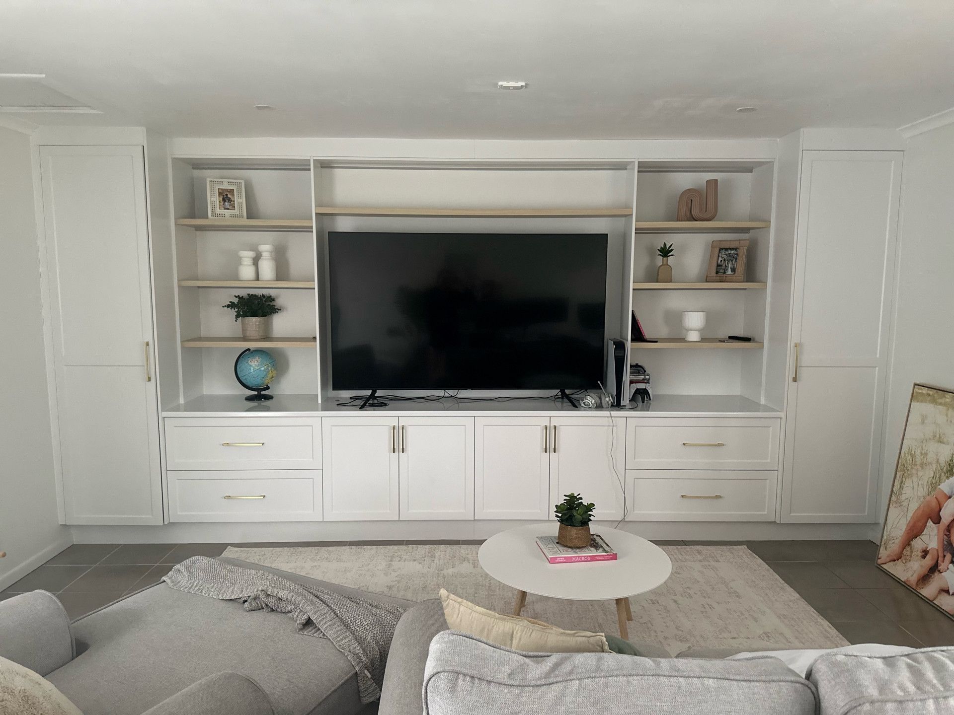 White Built-In Entertainment Center with Tv, Shelves, and Cabinets in A Living Room — Valley Cabinetmakers In Biloela, QLD 