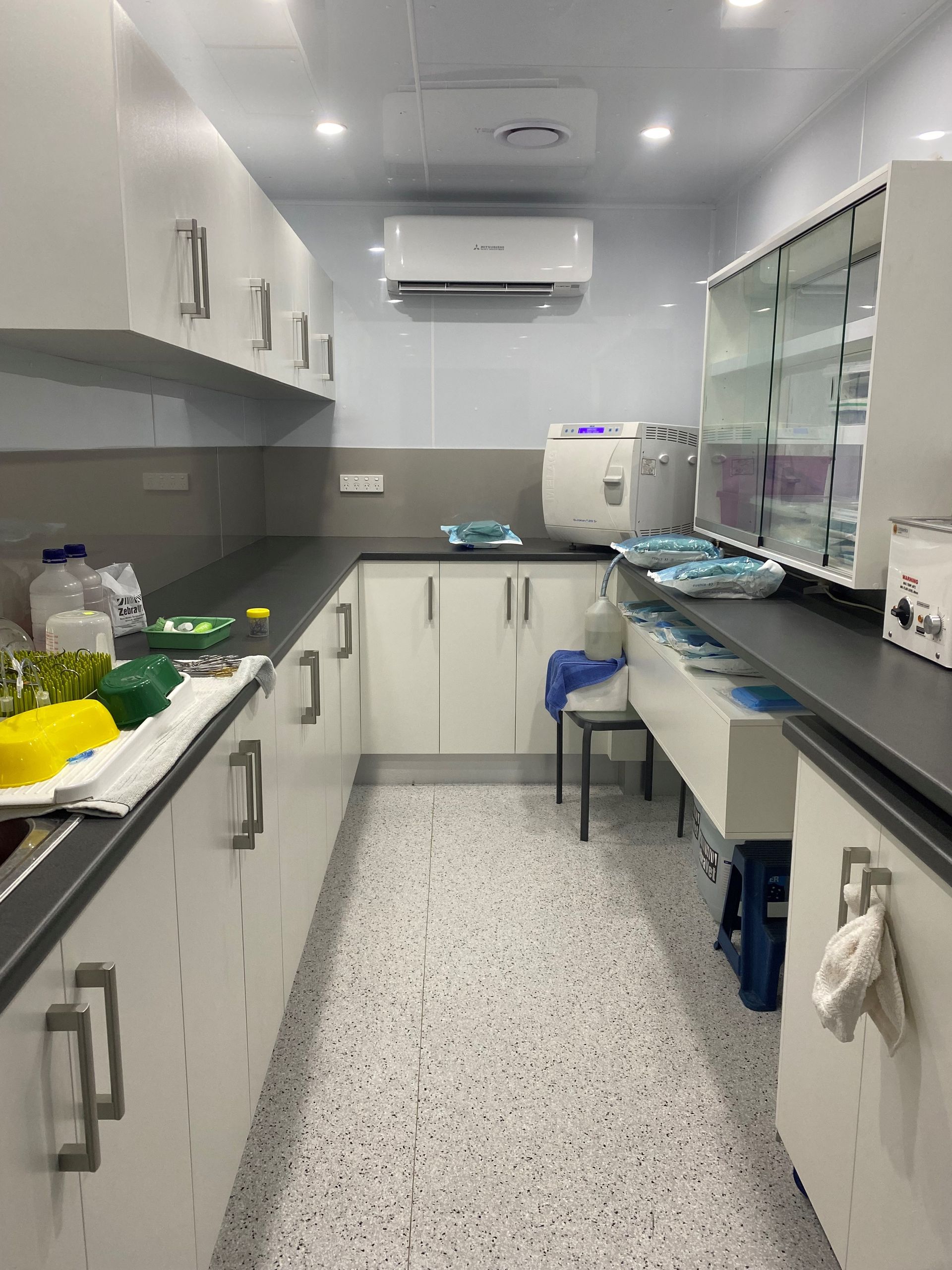 Built-In Bedroom Closet with Sliding Doors, a Mirrored Center Panel, and Gold Trim; Neutral Colour Scheme — Valley Cabinetmakers In Biloela, QLD 