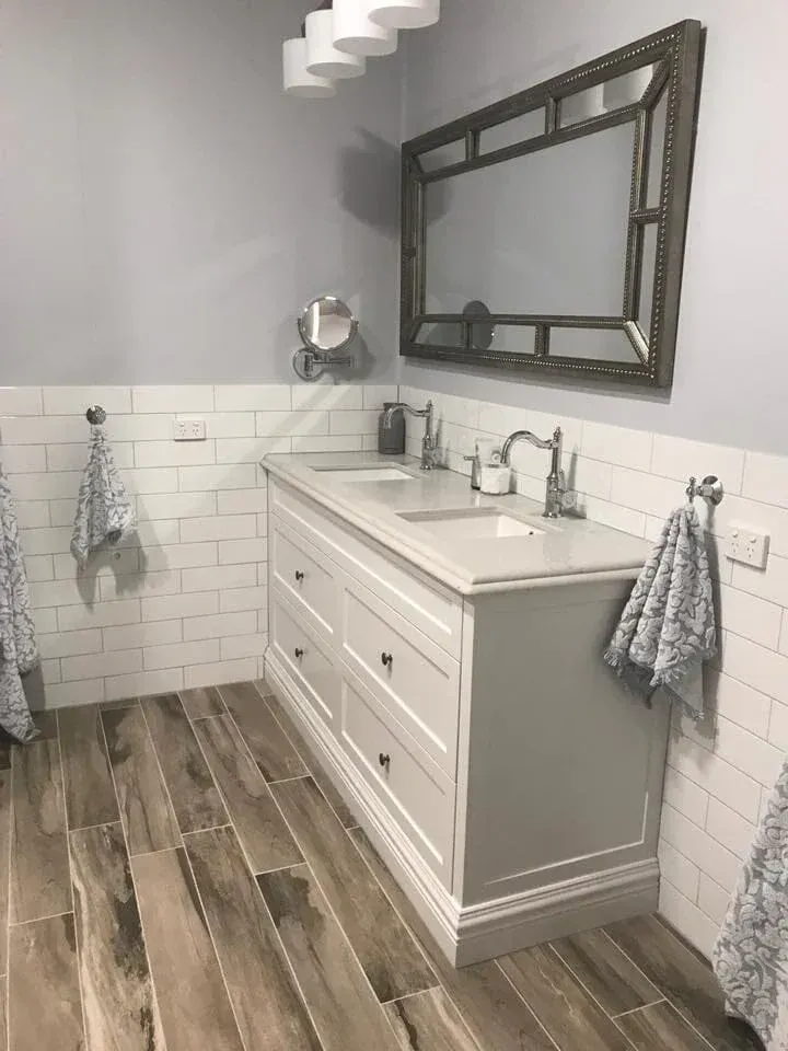 Bathroom with White and Gray Vanity, Large Mirror, and Wood-Look Tile Floor — Valley Cabinetmakers In Biloela, QLD 