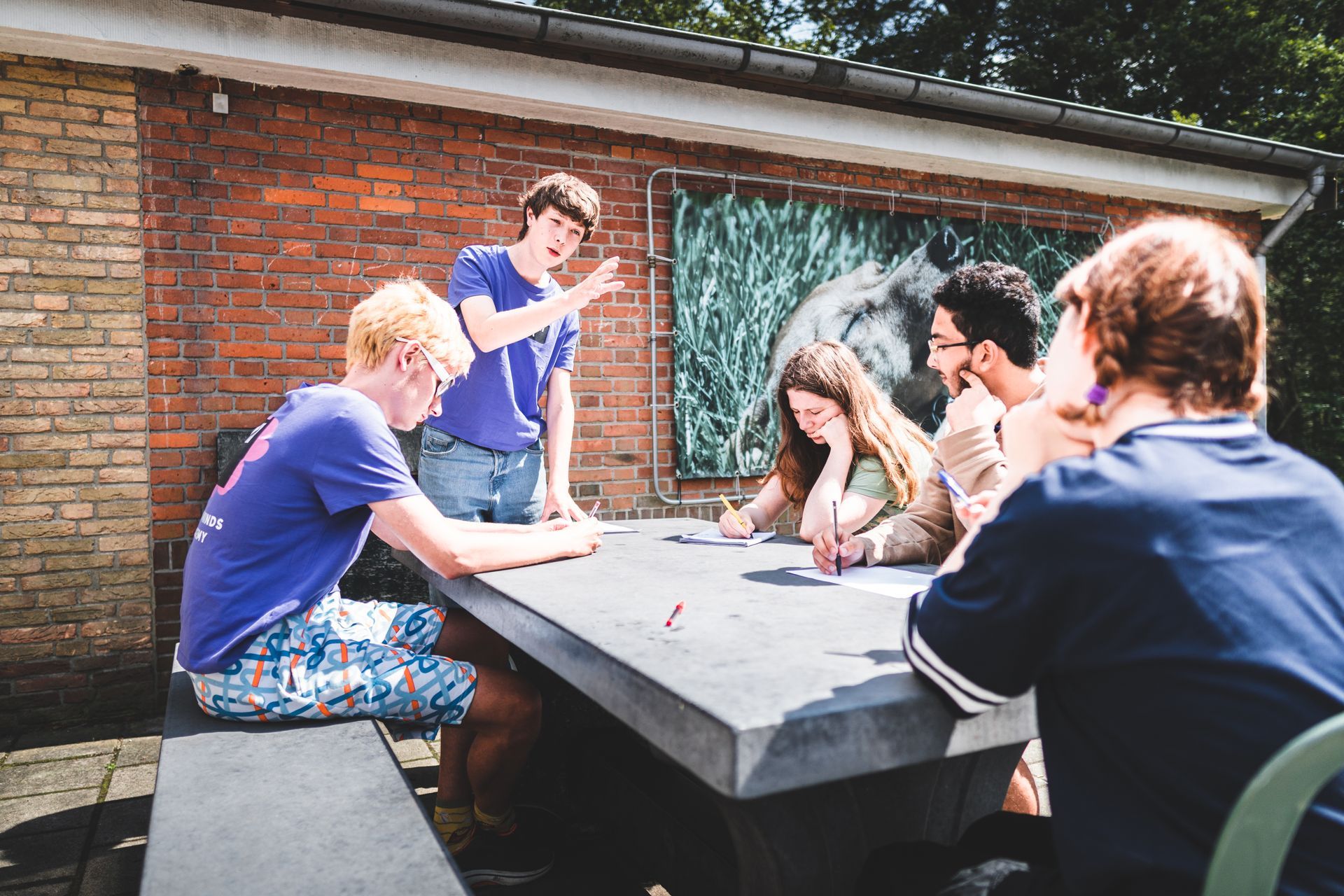 A group of people are sitting around a table doing a debate.