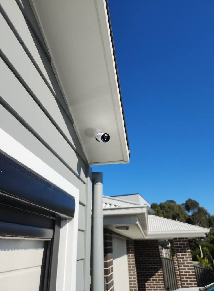 Security Camera Mounted Under the Eaves of a House — Wetzel Electrical in Wollongong, NSW