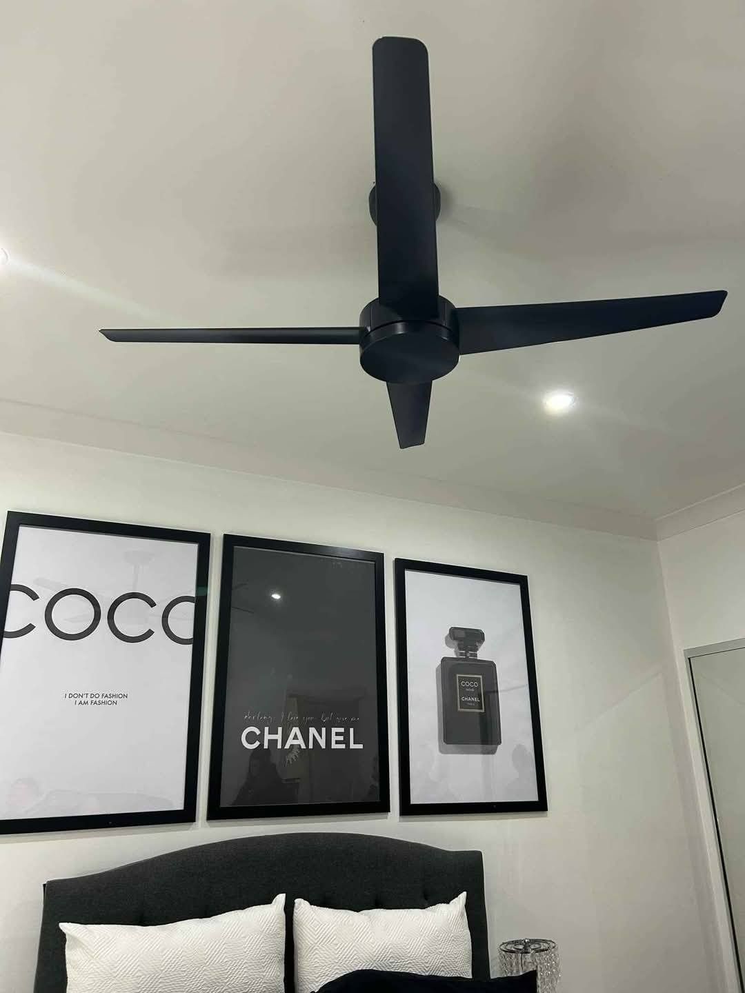 Black Ceiling Fan Above With Framed Chanel Posters — Wetzel Electrical in Wollongong, NSW