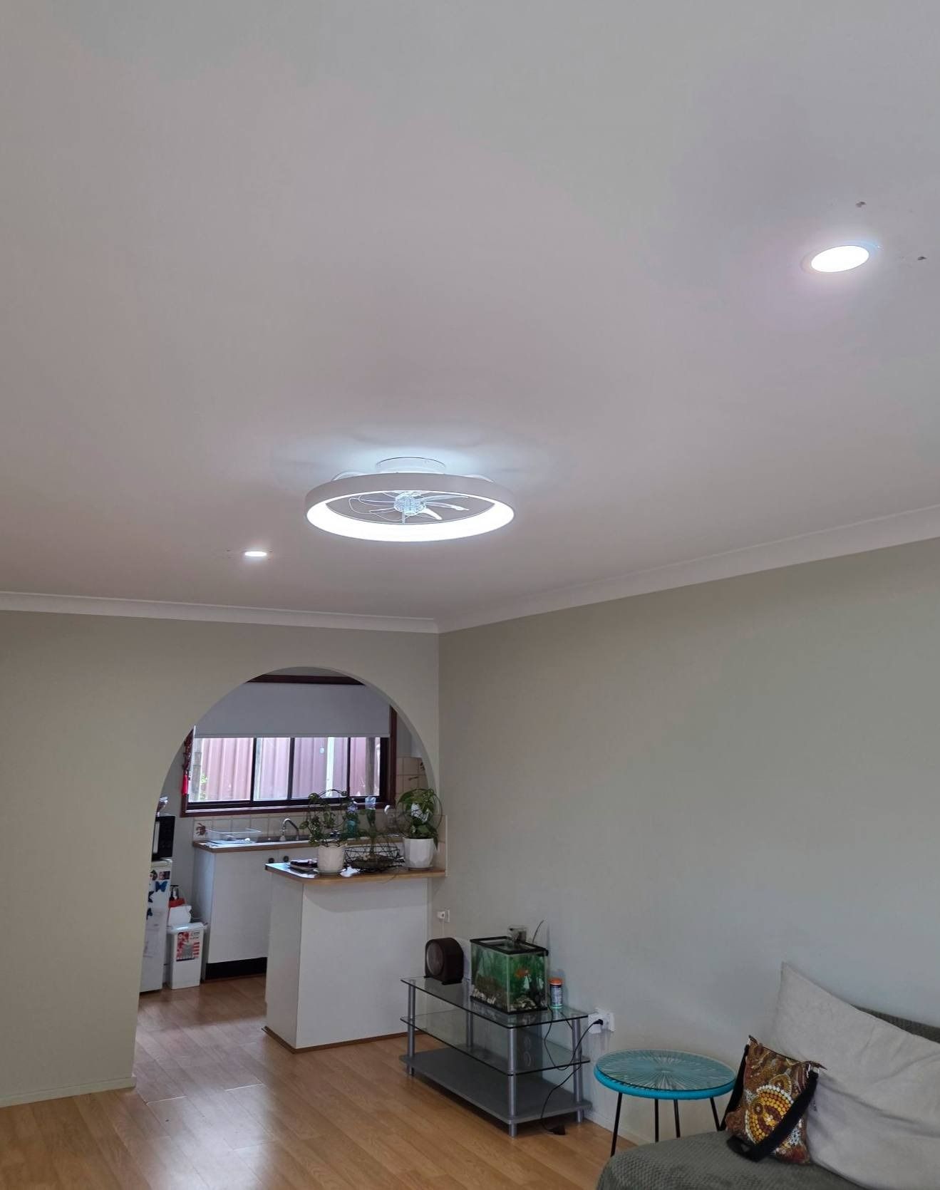 Living Room With White Ceiling Archway to Kitchen and Modern Ceiling Light — Wetzel Electrical in Dapto, NSW