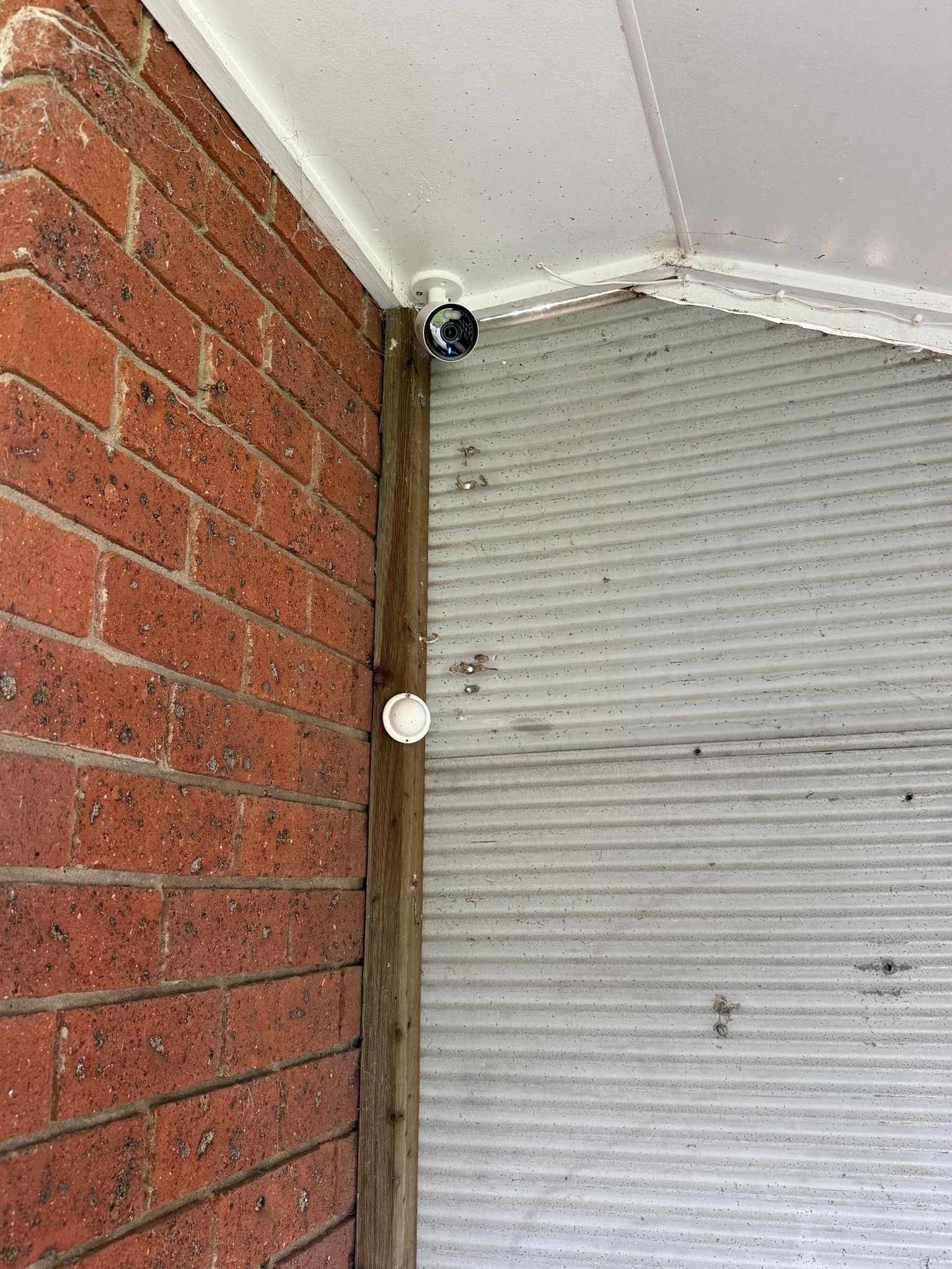Security Camera and Light Fixture Mounted on a Brick Wall — Wetzel Electrical in Dapto, NSW