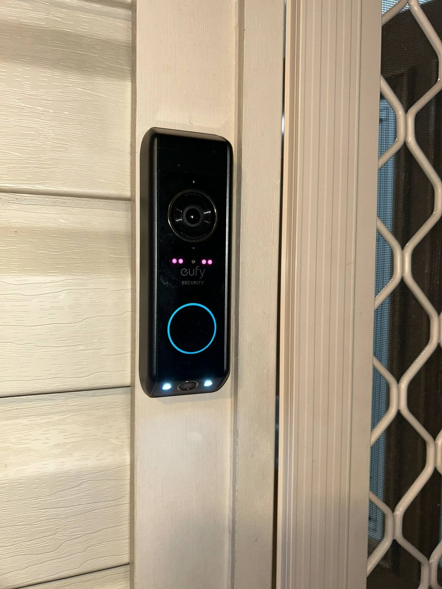 Black Doorbell Camera Mounted on a White Door Frame — Wetzel Electrical in Shellharbour, NSW