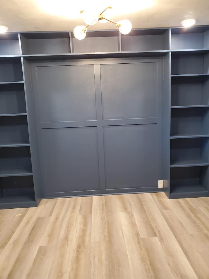 A room with a lot of shelves and a sliding door.