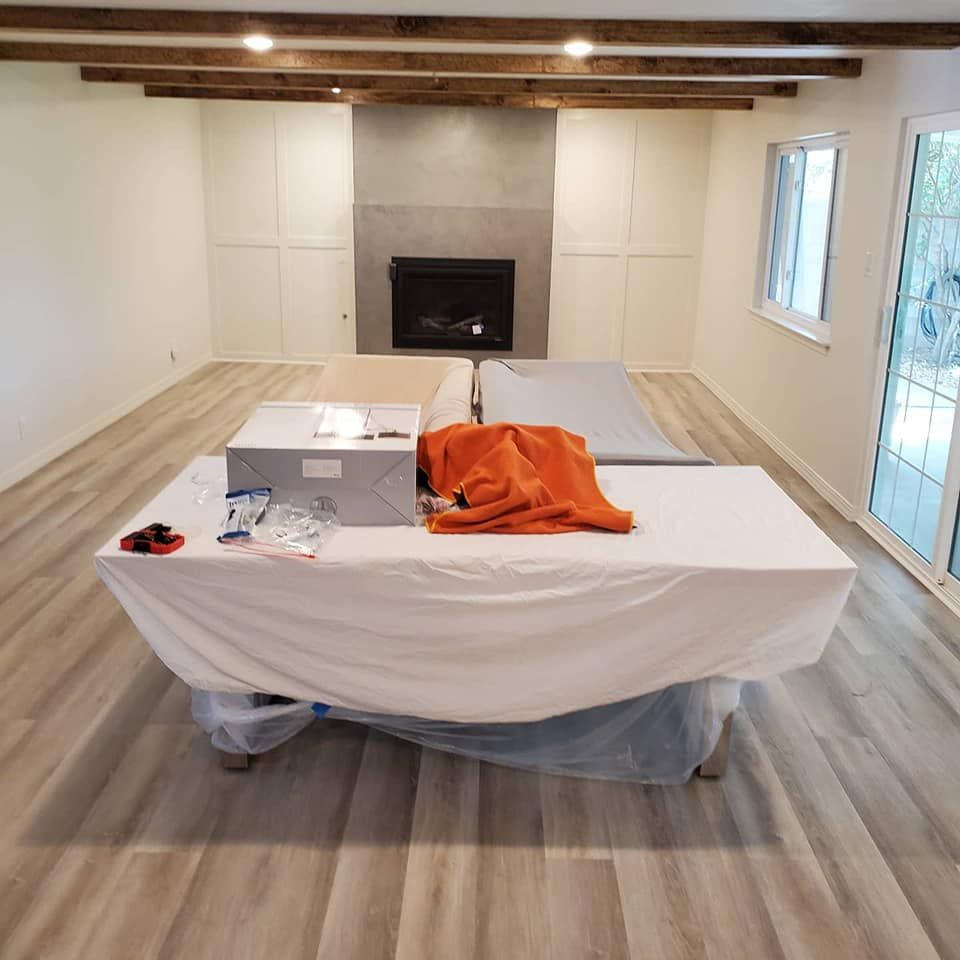 A table with a white cloth on it is in a room with a fireplace.