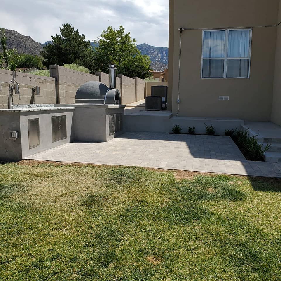 The backyard of a house with a pizza oven