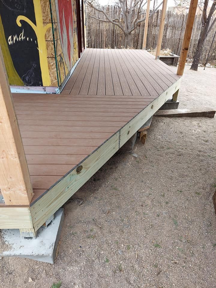 A wooden deck is being built next to a building.