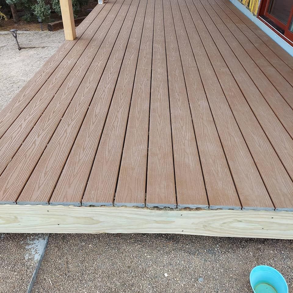 A wooden deck with a blue bowl on the ground